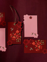 Blossom Notes gift tags in deep red with flame flowers and gold eyelets