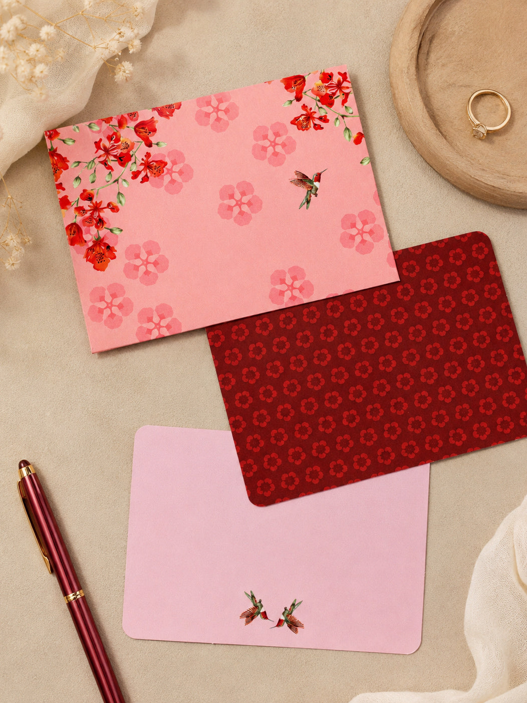 Blossom Notes thank-you card faces — lifestyle with pen and ring