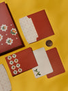 Mango Tales thank-you cards in terracotta with white star florals